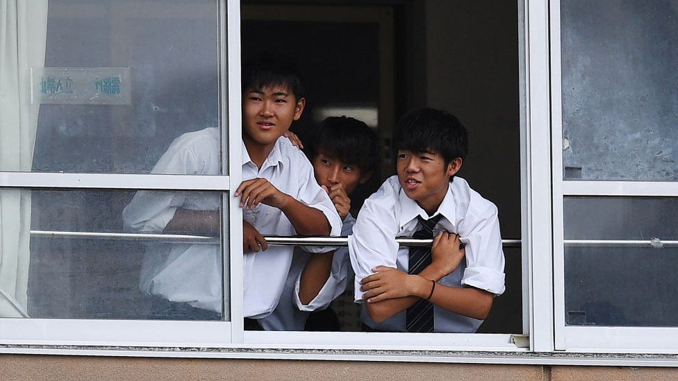 Students watch rugby practice from their classroom in Ichihara