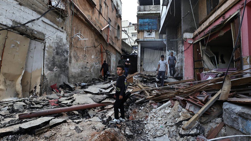Palestinians inspect the damage to a street after a raid by Israeli forces in the Nur Shams camp for Palestinian refugees in the occupied West Bank on 21 April