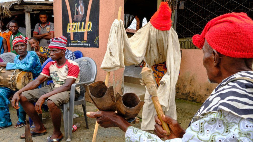 Men sat during an Igbo meeting