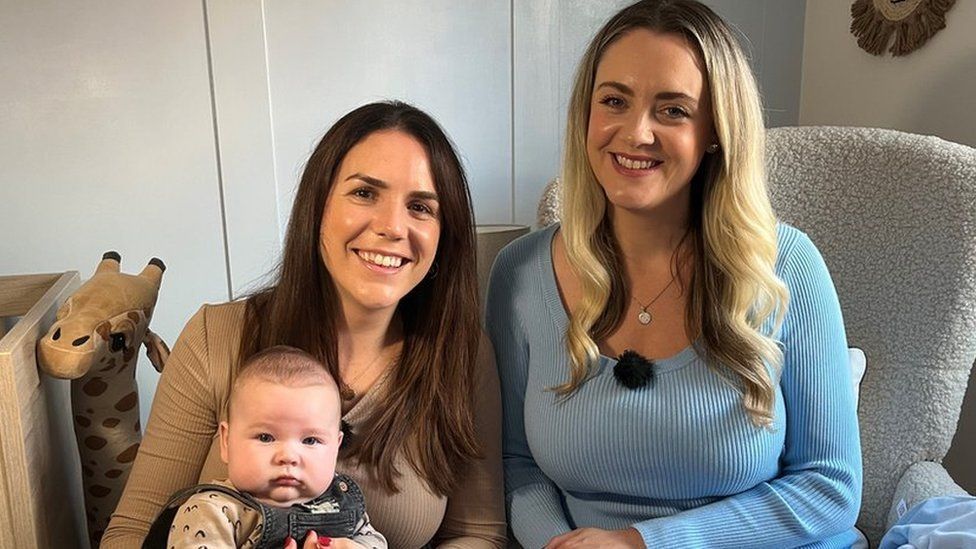 Sarah Maultsaid and Emma Baker with son Louis