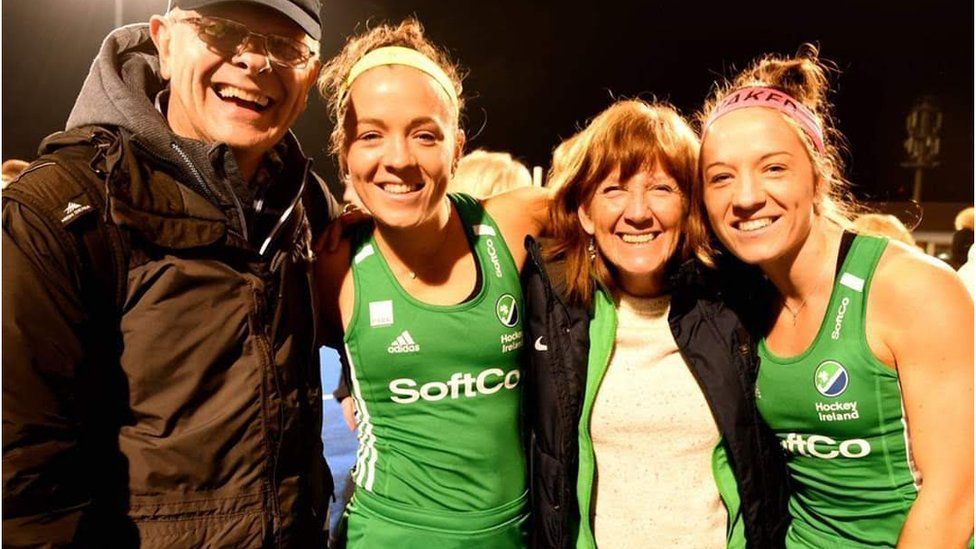 Bethany and Serena Barr pictured pitch-side with their mum and dad