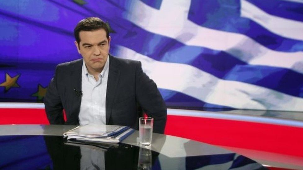 Greek Prime Minister Alexis Tsipras (R) gives an interview to Greece"s state television ERT on Monday night, in Athens, Greece, 29 June 2015.