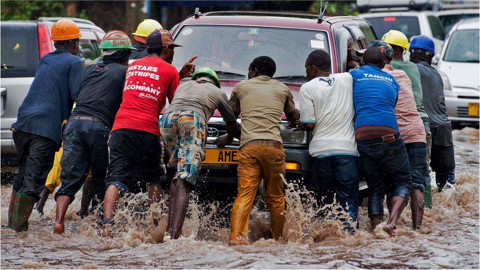 Men push a stranded motorist out of a flooded street in Dar es Salaam, Tanzania - Wednesday 23 November 2016