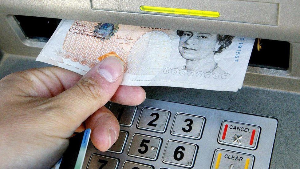 Man withdrawing £10 from cash machine