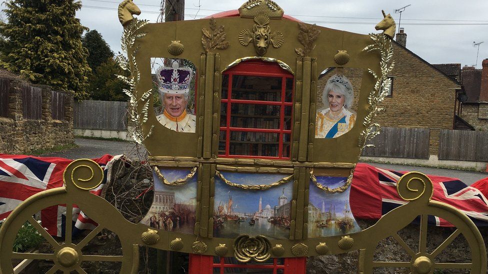 The village's telephone box decorated for the coronation of King Charles III
