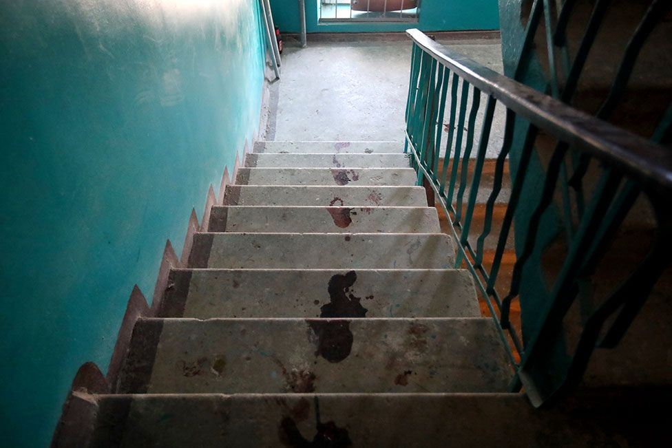 Bloodstains are seen on the stairs in a residential building following shelling in Piatykhatky, Kharkiv, north-eastern Ukraine