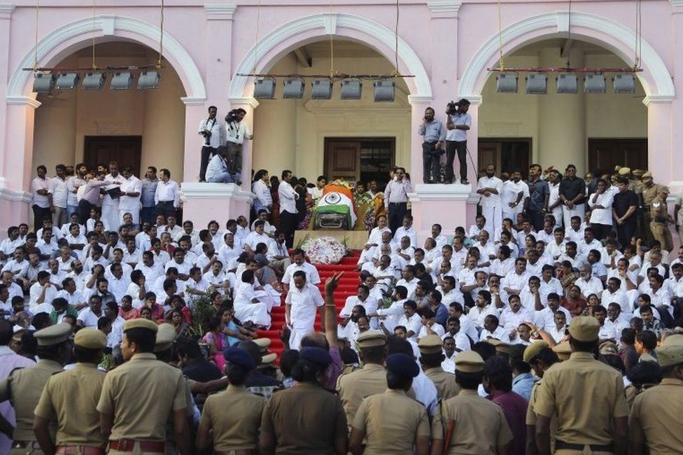 Body of India"s Tamil Nadu state former Chief Minister Jayaram Jayalalithaa is wrapped in the national flag and kept for public viewing outside an auditorium in Chennai, India, Tuesday, Dec. 6, 2016.