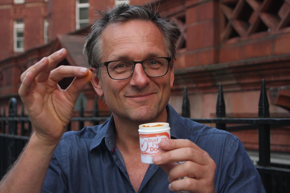 Michael Mosley holding a pinch of turmeric