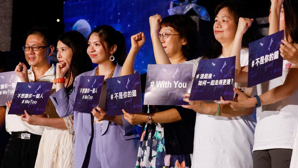 Singers and activists hold placards while taking a group photo at a concert to support #MeToo movement in Taipei, Taiwan July 22, 2023