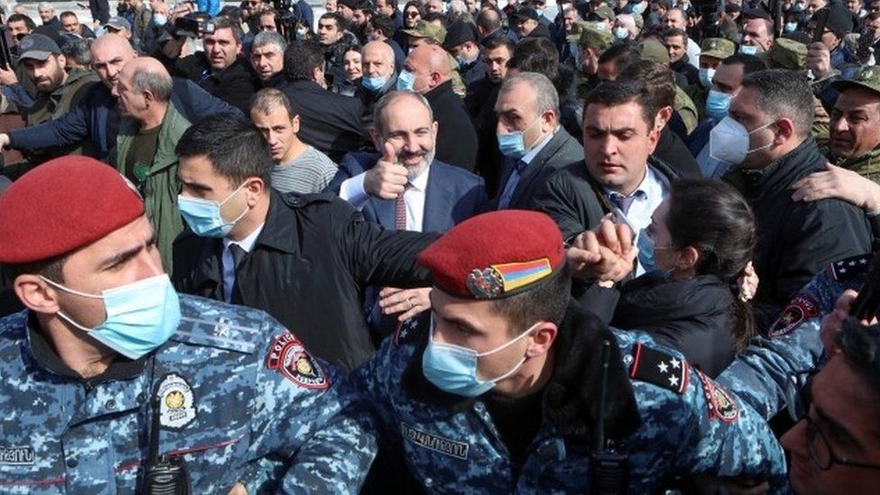 Armenian Prime Minister Nikol Pashinyan gives thumbs up (centre) surrounded by supporters and police in Yerevan. Photo: 25 February 2021