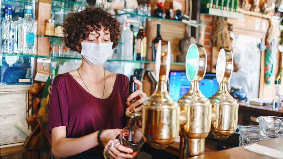 A woman pulling a beer