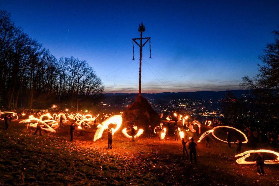 People light the Easter fire with burning torches on a hill in Attendorn, western Germany on April 9, 2023.