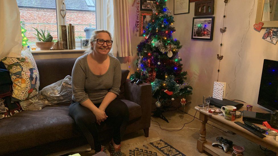Sarah Brackstone at home with a Christmas tree