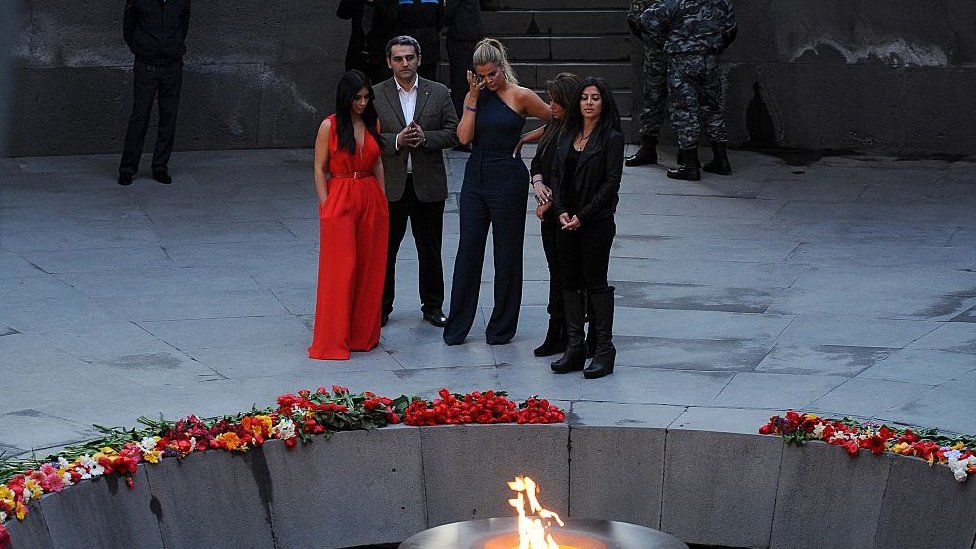 US reality TV star Kim Kardashian (L) and her sister Khloe (3rdL) visit the genocide memorial, which commemorates the 1915 mass killing of Armenians in the Ottoman Empire, in Yerevan