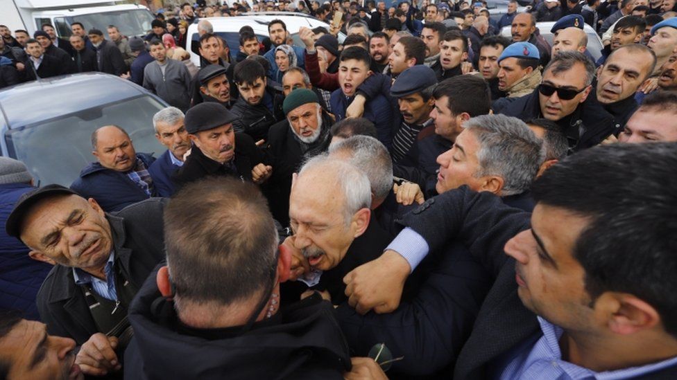 Kemal Kilicdaroglu being jostled by crowds at a funeral