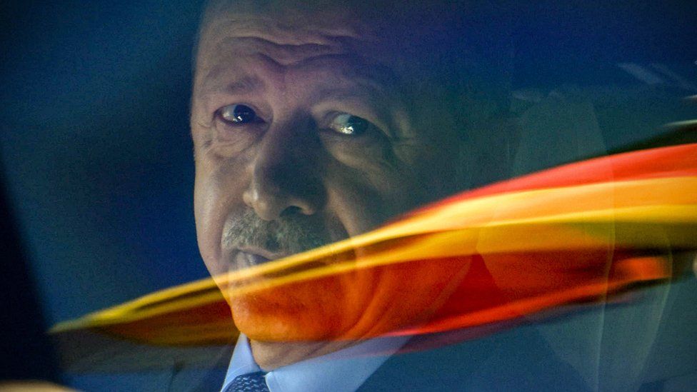 Turkish President Recep Tayyip Erdogan sits in a car behind a reflection of the German flag as he departs after his arrival from the Berlin Tegel Airport for an official visit in Berlin, Germany, 27 September 2018.