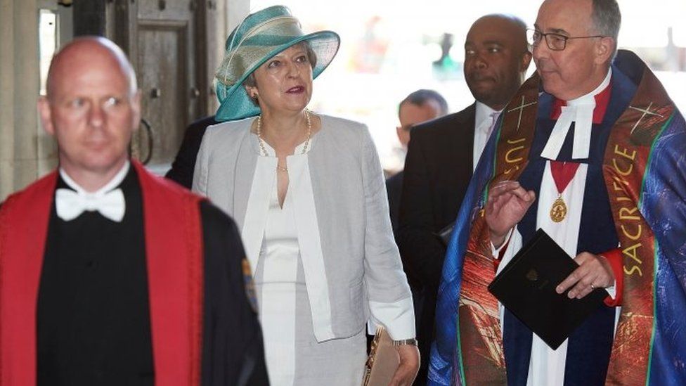 Theresa May with the Dean of Westminster John Hall (right)