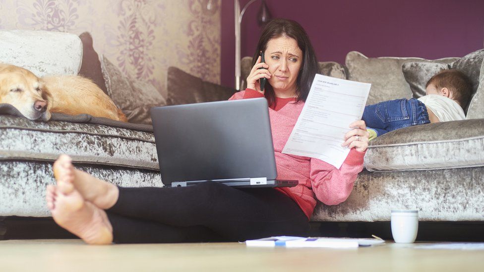 A stock image of a woman troubled by a bill