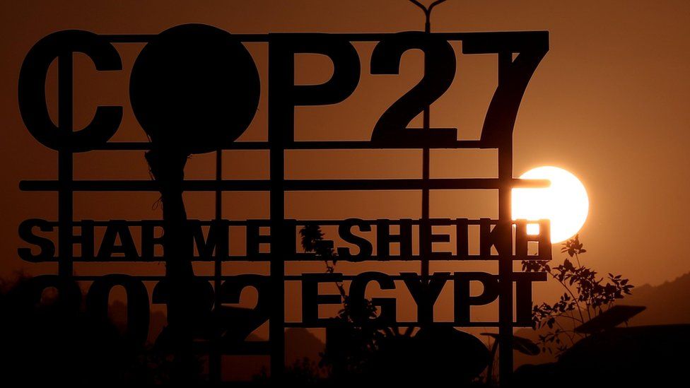 The sun sets behind the International Congress Center before the 2022 United Nations Climate Change Conference