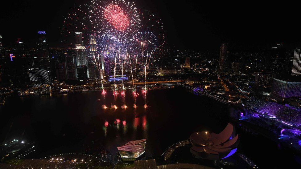 Fireworks burst over the water of Marina Bay during the New Year countdown celebration in Singapore