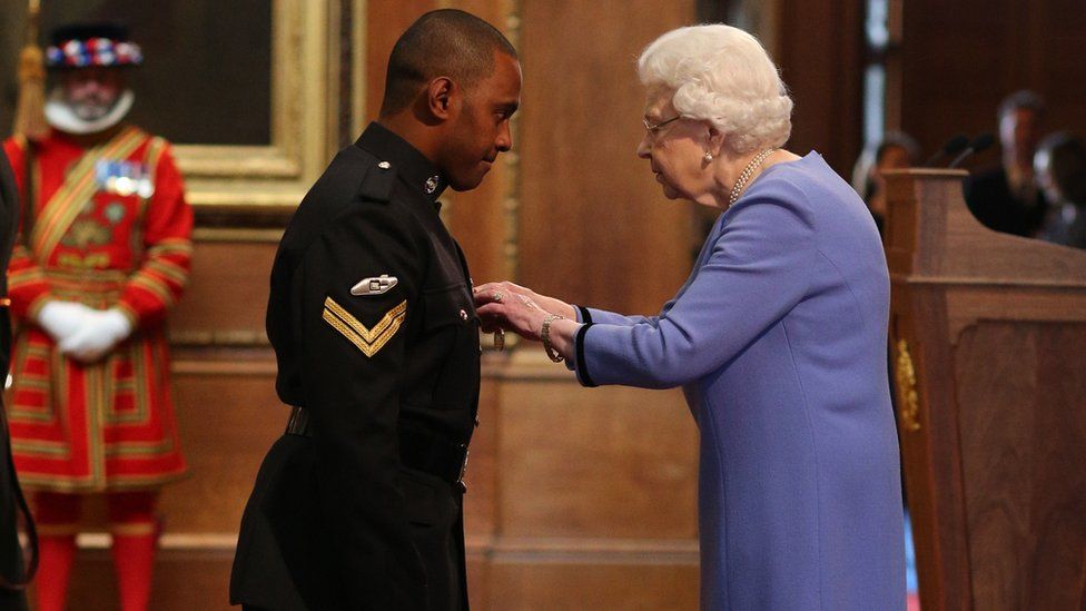 Corporal Saimone Qasenivalu presented the Queen's Gallantry Medal by Her Majesty