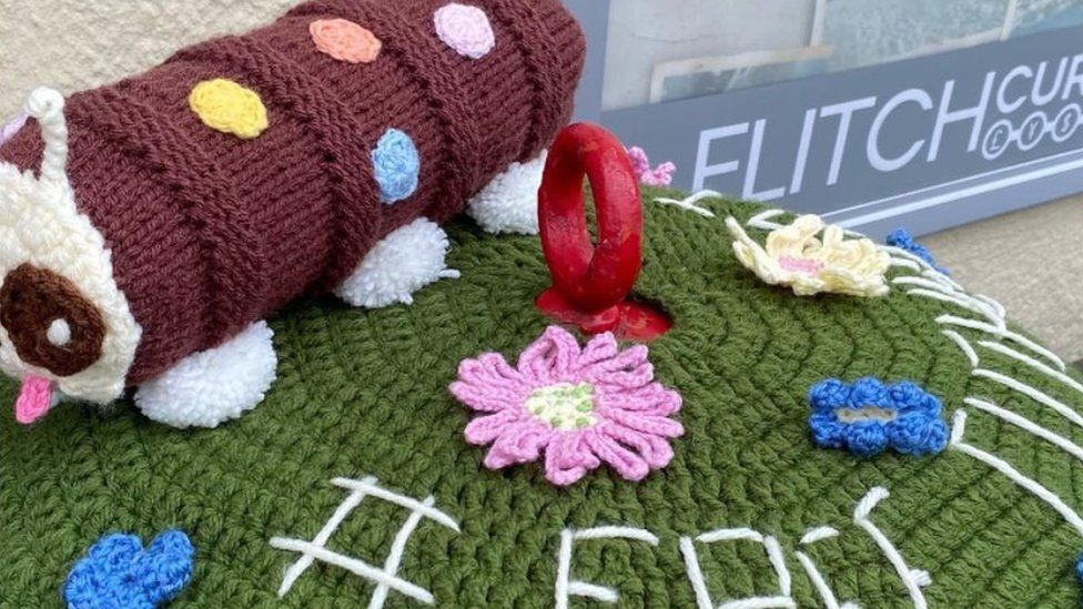 Knitted Cuthbert the caterpillar cake