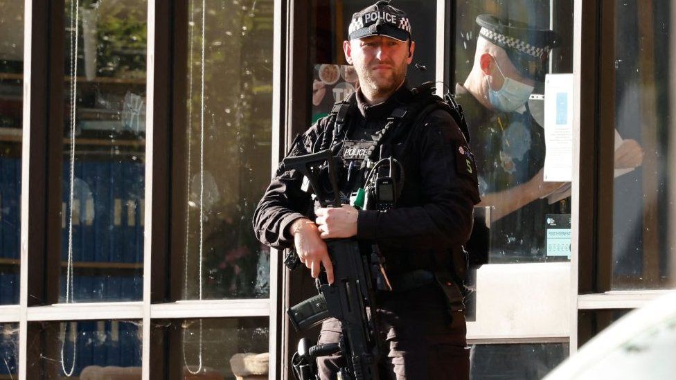 Armed police stood guard outside the scene of the stabbing.