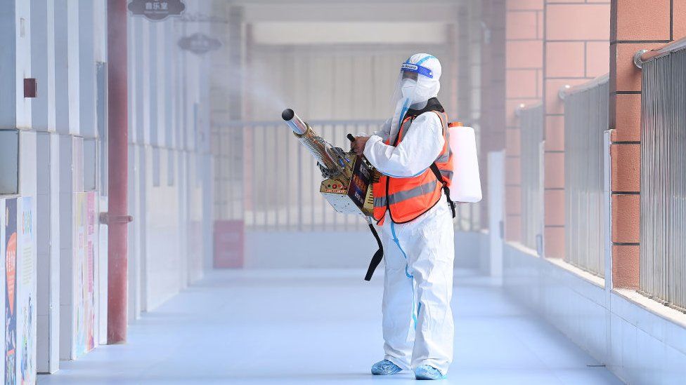 Worker disinfects primary school in Wuhan on 25 August 2021. Photo Barcroft Media