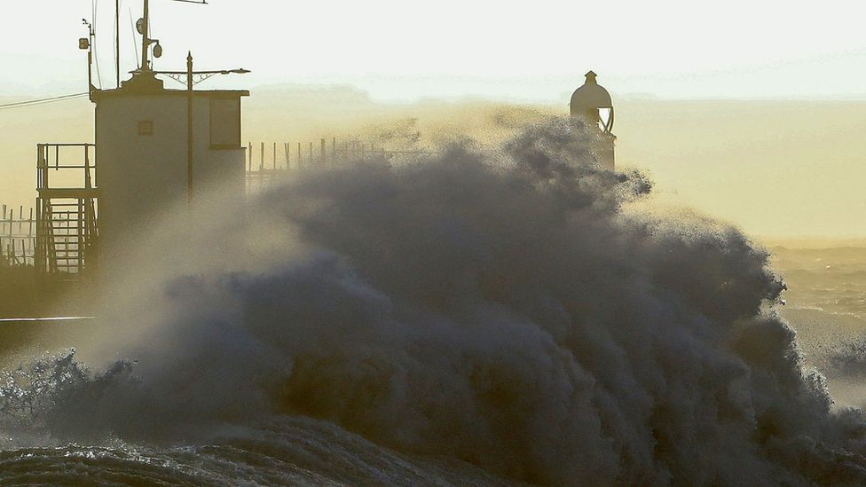 Large waves crashing onto a pier