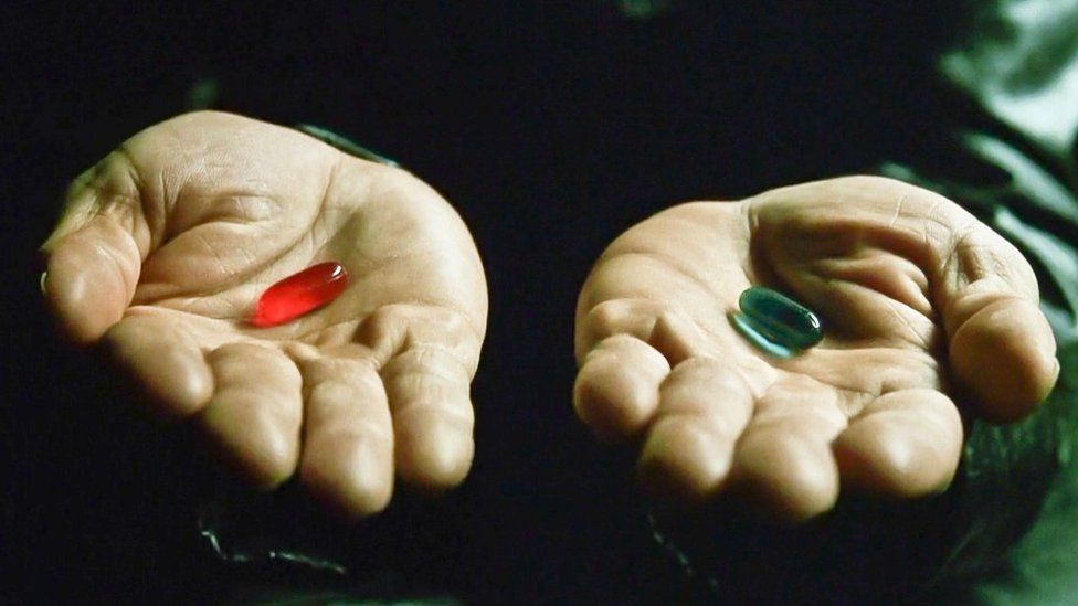 Morpheus offering Neo the red pill or blue pill. 