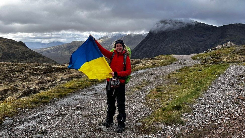 Sofiia Volovyk holding the Ukrainian flag on Ben Nevis