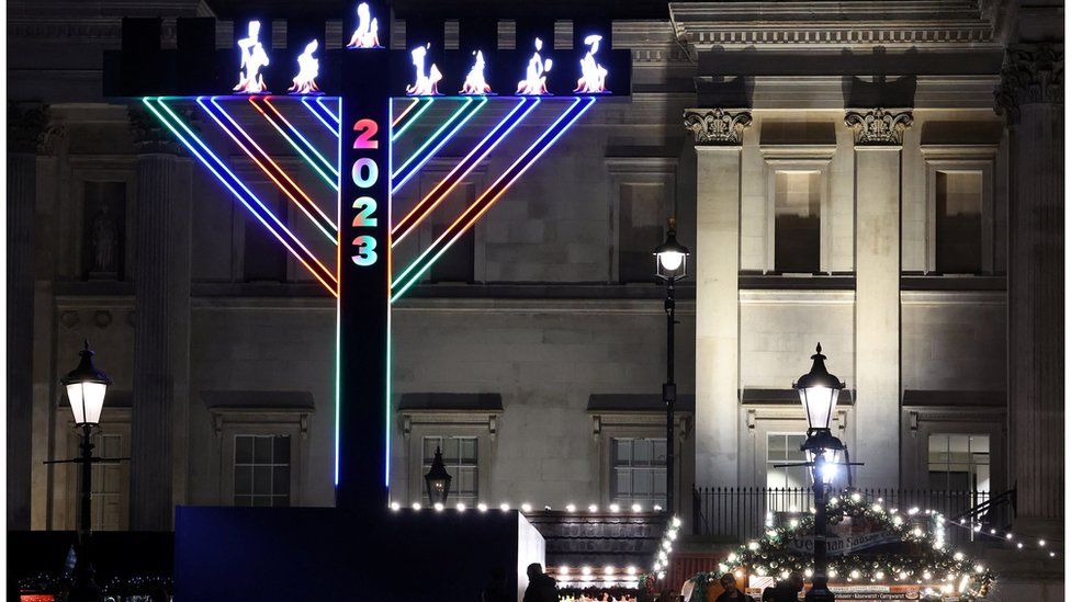 Visitors view a menorah illuminated for the Jewish festival of Hanukkah in Trafalgar Square