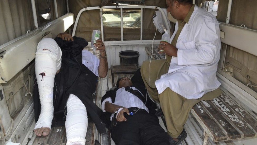 Injured lawyers receiving treatment in back of pick-up truck