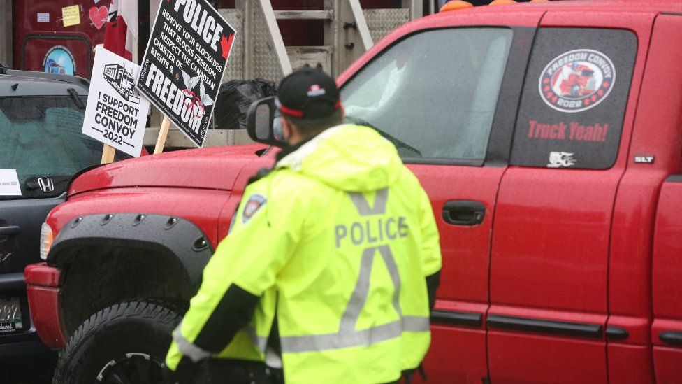 Ottawa Police hand out papers telling the truckers to leave or face arrest