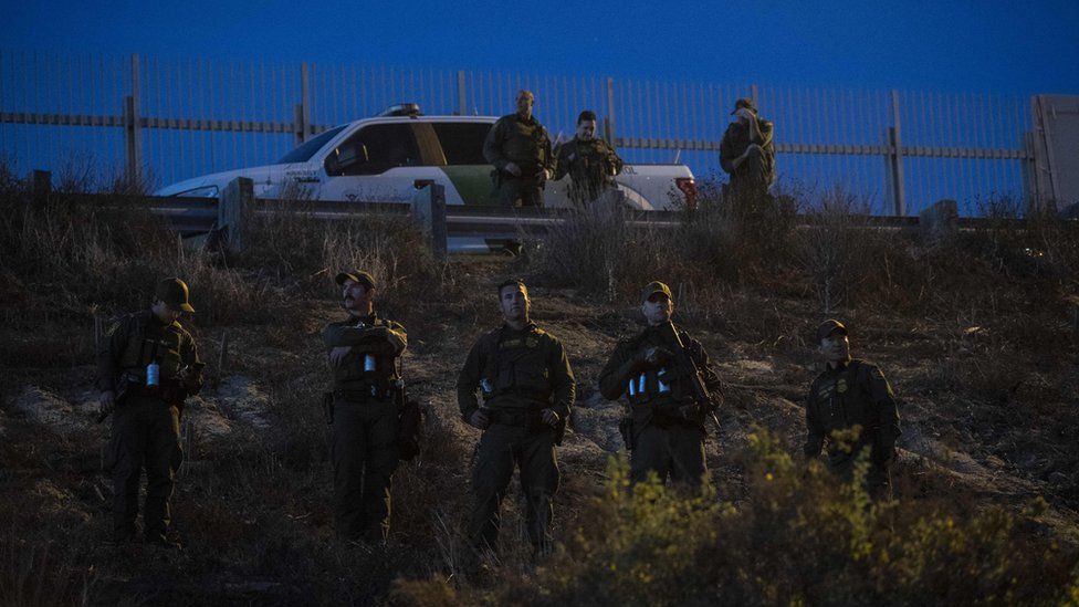 US Border Patrol agents stand guard as they look for illegal immigrants