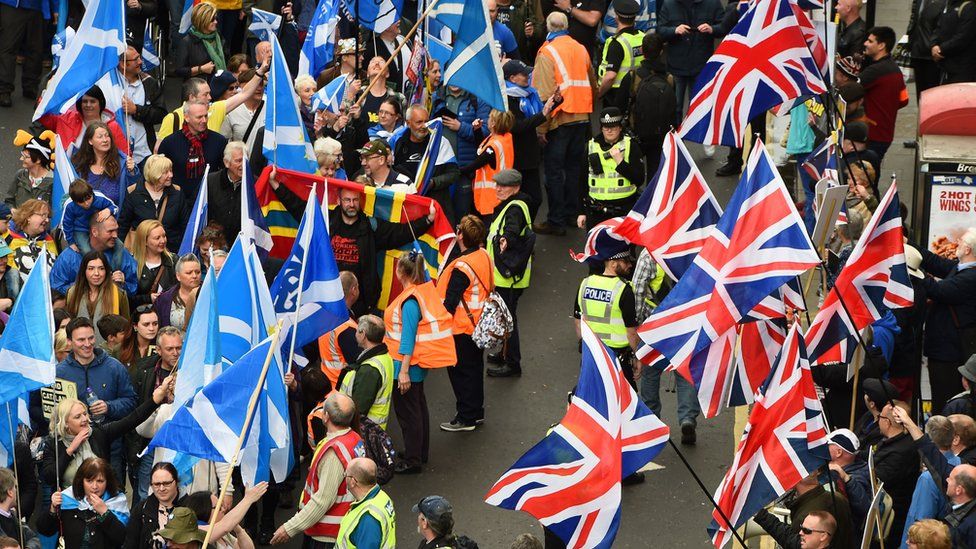 Anti-independence supporters wave Union Jack flags as other demonstrators carry Saltire flags, the national flag of Scotland