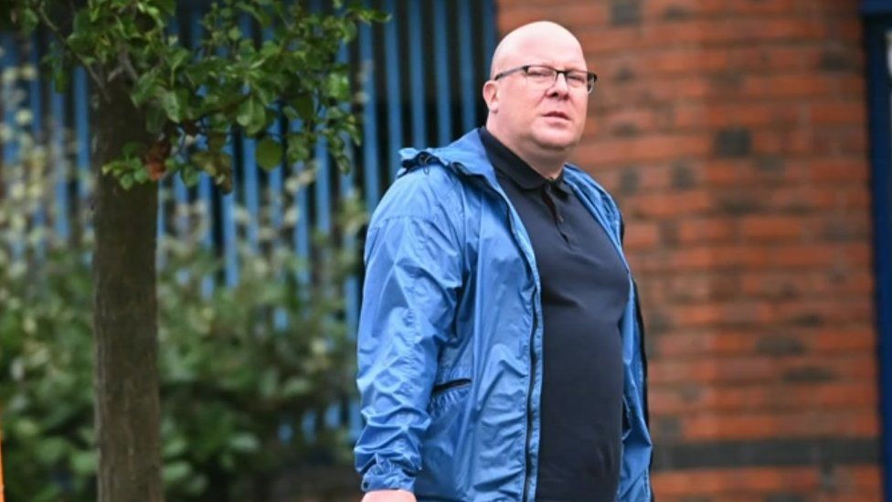 John Owen wearing a blue jacket and standing outside