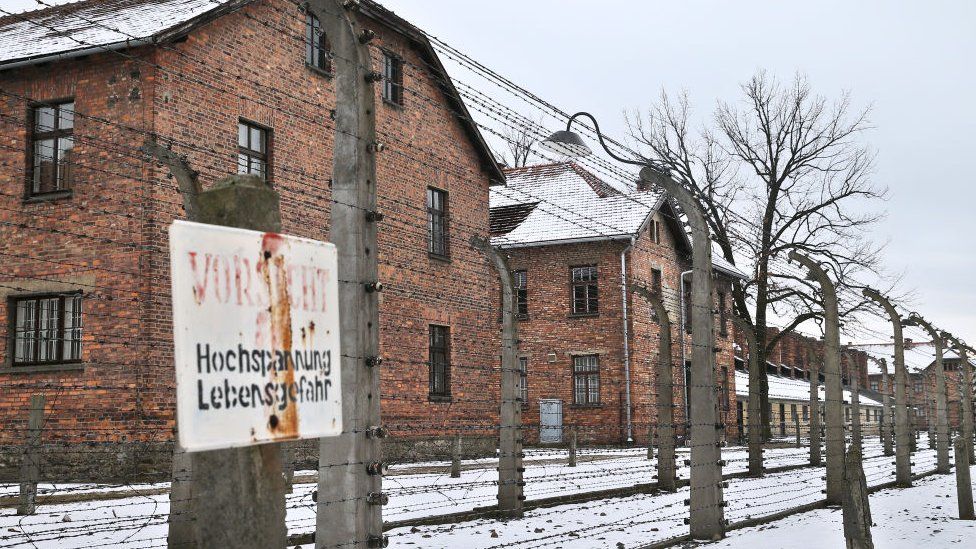 The barbed wire and buildings at the former Auschwitz concentration camp