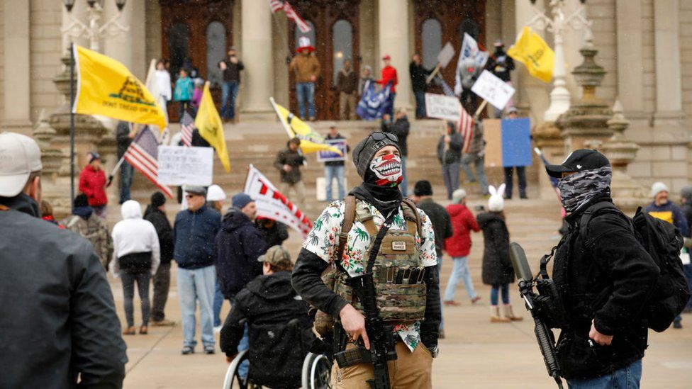People take part in a protest for "Michiganders Against Excessive Quarantine" at the Michigan State Capitol in Lansing, Michigan on April 15, 2020