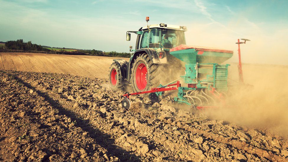 A tractor ploughing a field