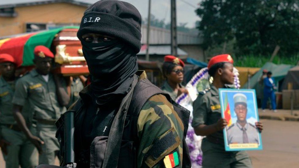 A soldier from the Rapid Intervention Battalion (BIR), provides security at a ceremony honouring four soldiers killed in after violence that erupted in the Northwest and Southwest Regions of Cameroon, where most of the country's English-speaking minority live, in Bamenda on November 17, 2017.