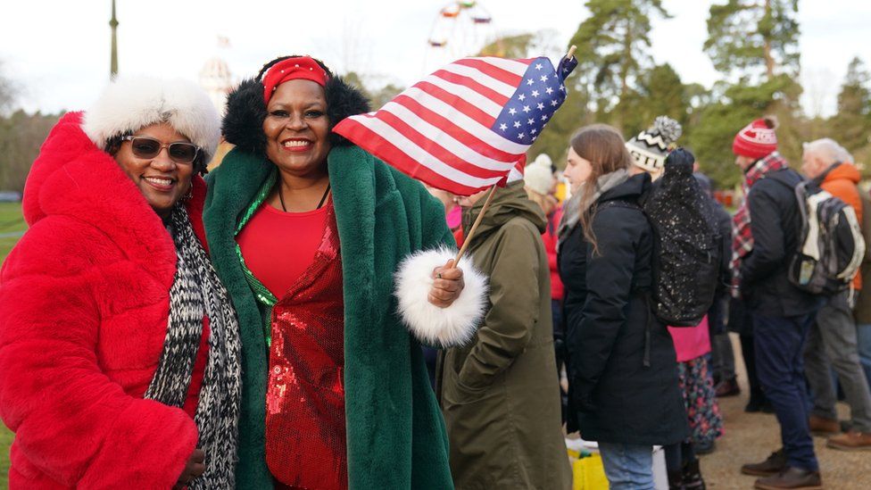 Two women in bright red and green coats