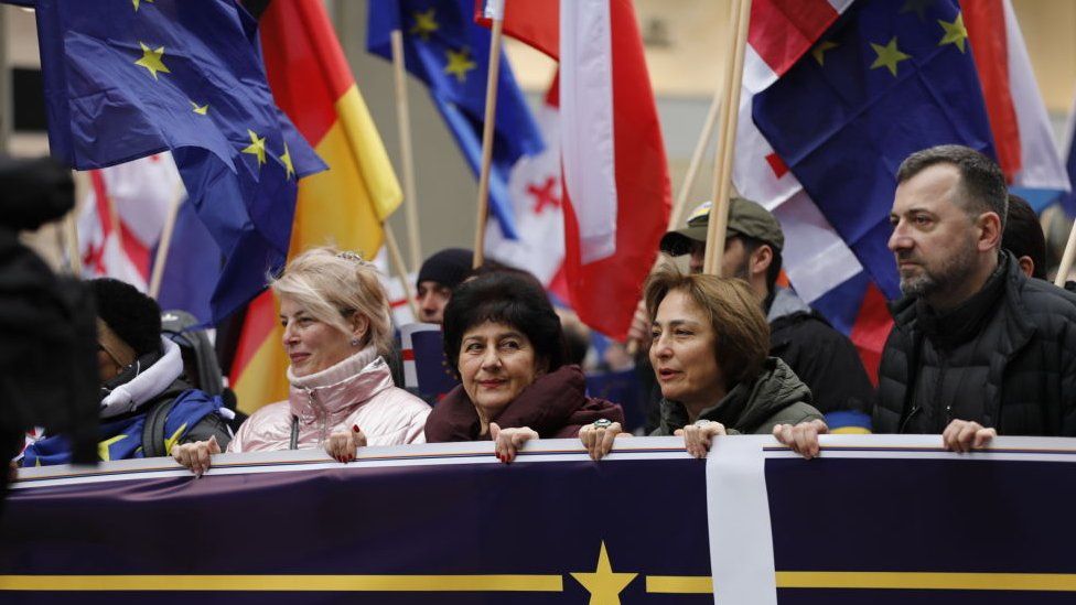 Participants spread a huge EU flag, symbolizing the European aspirations of the entire Georgian society, during a march starting from First Republic Square to end at Europe Square, to support Georgia's EU membership bid in Tbilisi, Georgia on December 9, 2023