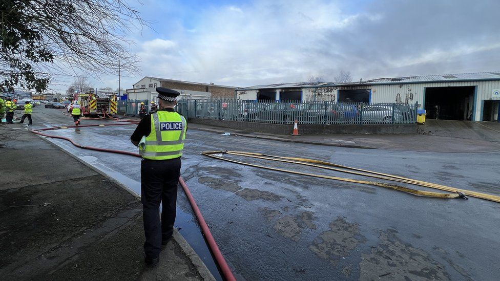 A police officer guarding the site of the fire