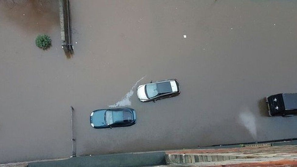 View from above of cars surrounded by water