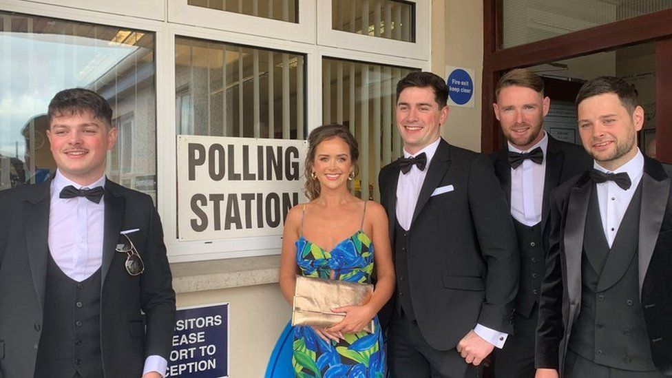 Pat Campbell and members of his wedding party stand outside the polling station at St Patrick’s Primary School in Clonoe after they voted in the council election