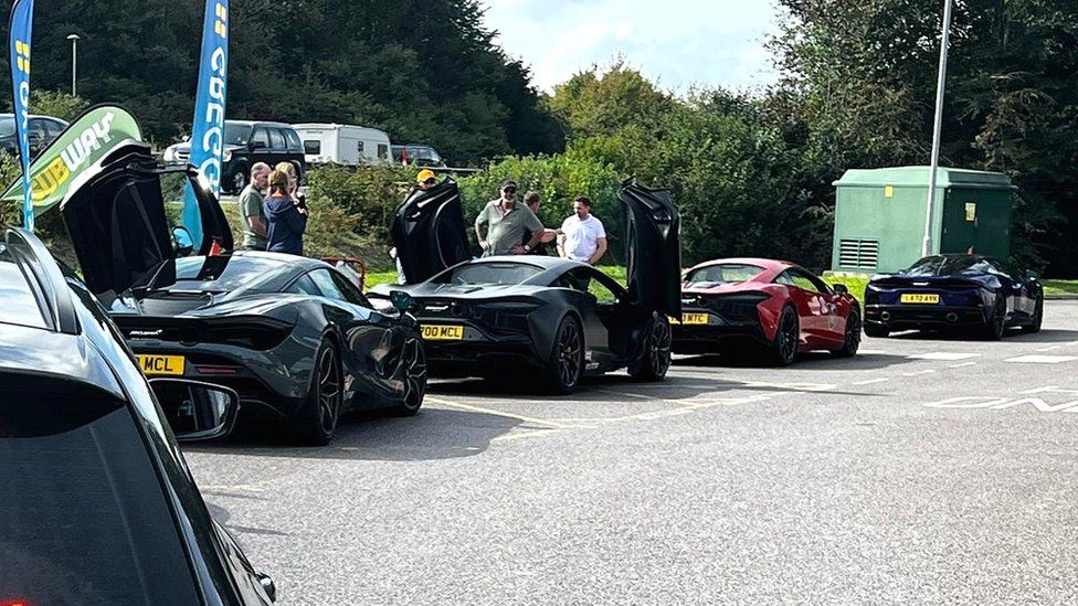 Mclaren sports cars lined up at the side of the road after being stopped by police