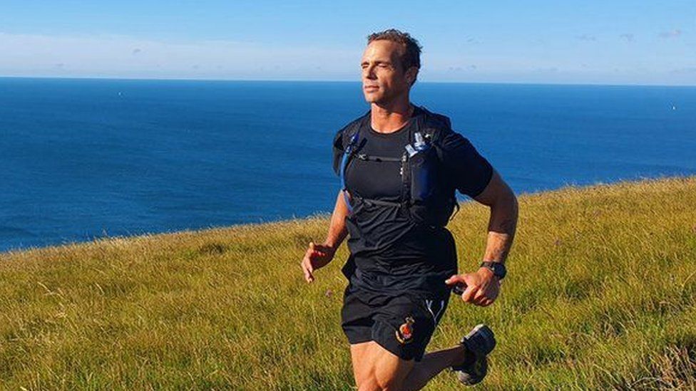 Paul Minter running by the sea