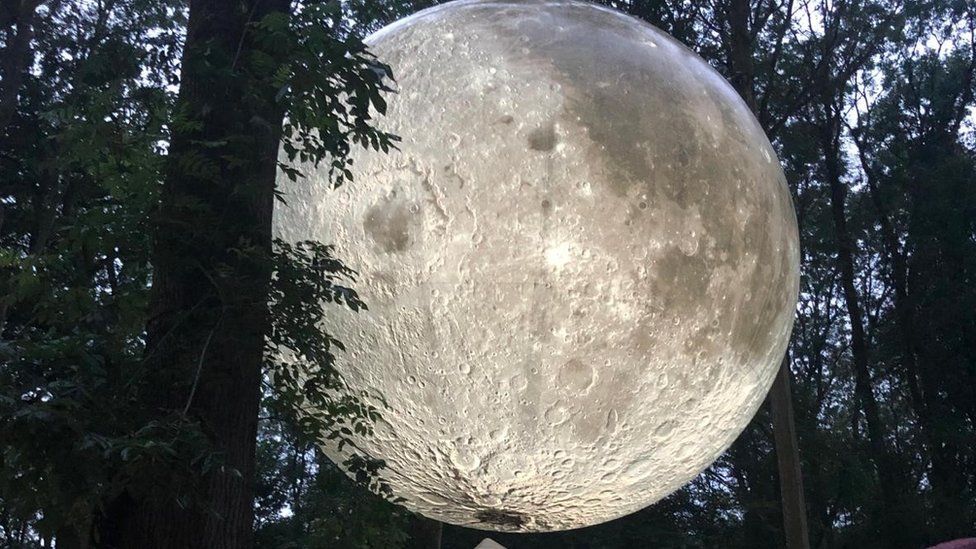 A giant moon sculpture at the festival