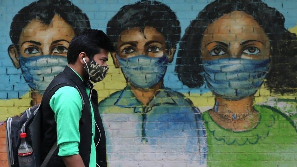 An Indian man passes by a mural on a wall to spread awareness about wearing a protective face mask to avoid spread of novel coronavirus in New Delhi, India, 07 November 2020.